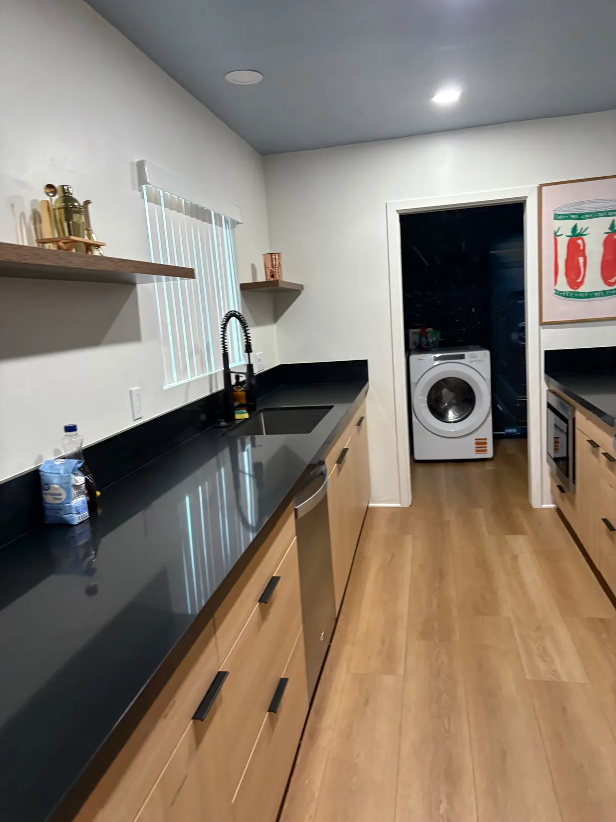 Galley kitchen with dark quartz counters after a cleaning