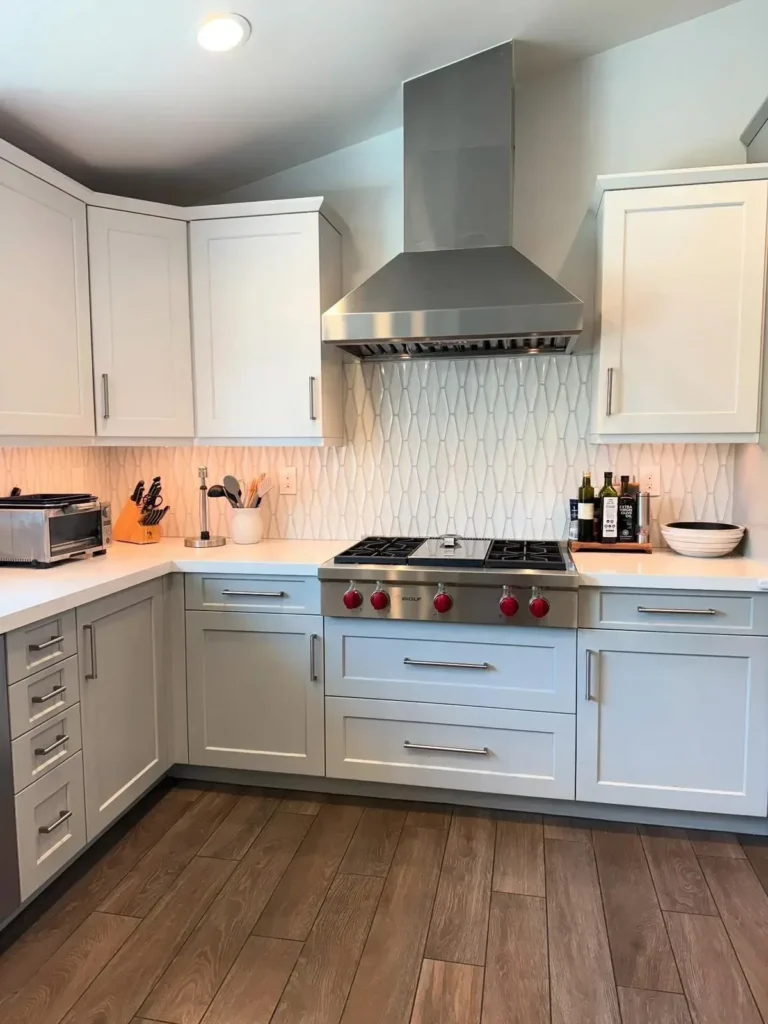 Kitchen with gray cabinets and a red-knob range after a deep clean