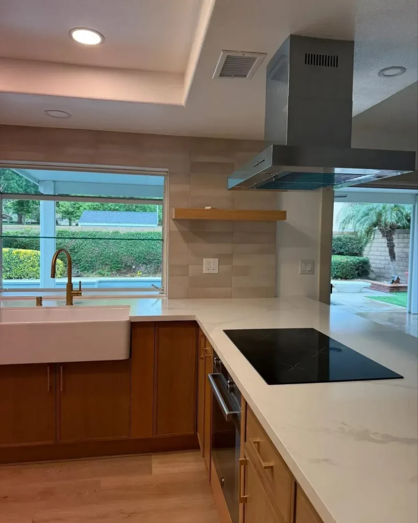 Kitchen with a brass pot filler and farmhouse sink after a deep clean