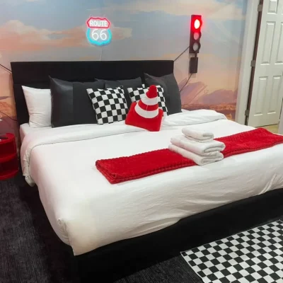 Themed Airbnb bedroom with fresh linens and folded towels